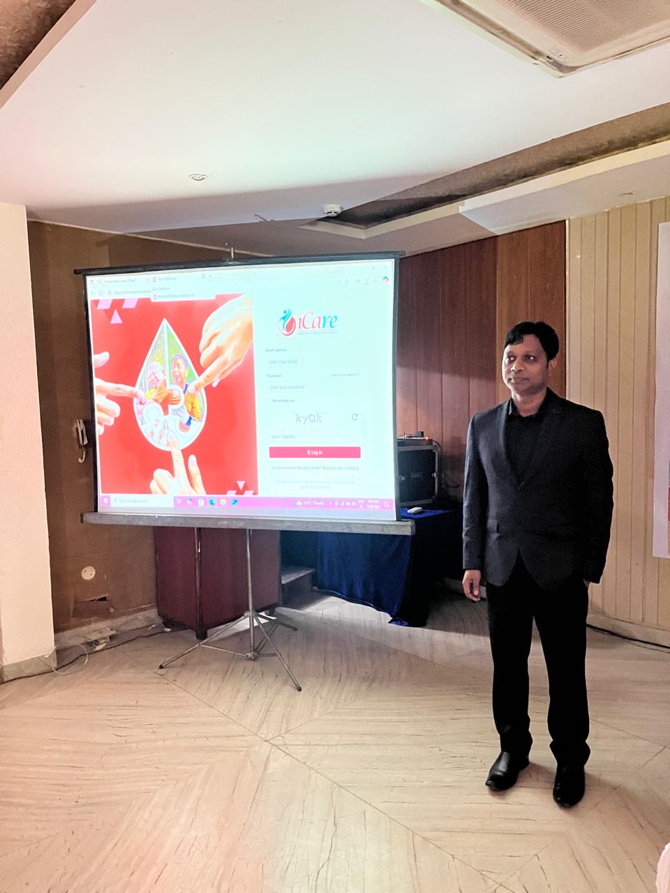 Speaker next to projector screen in PSACS workshop